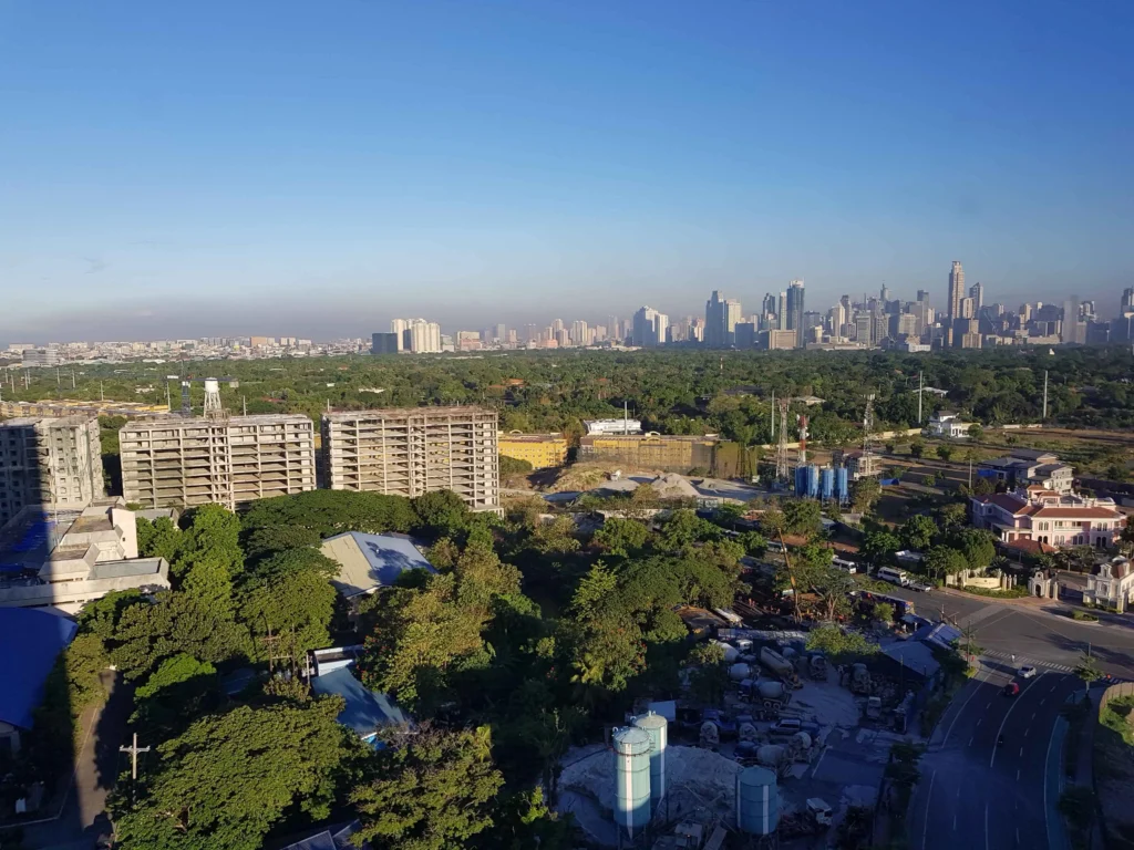 A high-angle shot showcasing luxury residential apartments in Gurgaon, set against a backdrop of greenery and modern infrastructure, highlighting prime investment areas.